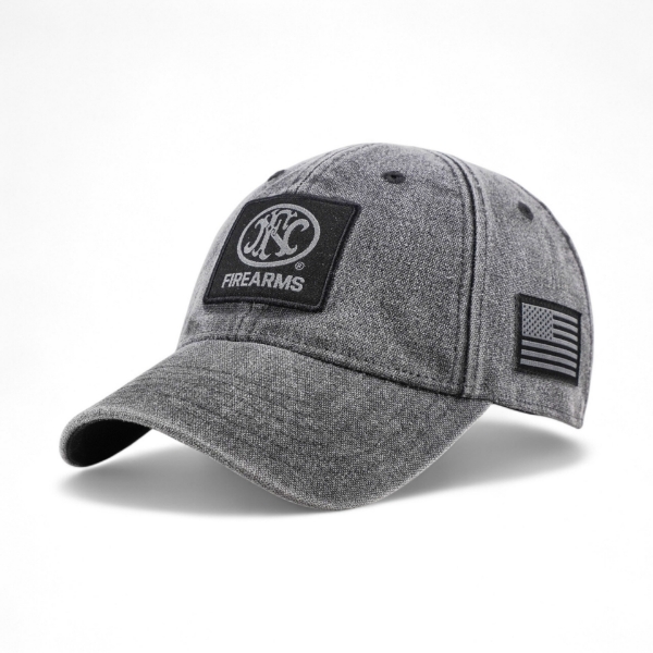 Angled front view of gray cap featuring FNH Firearms logo patch on front and American flag patch on side.