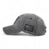 Left side view of heather gray baseball cap with curved brim and black American flag patch on side panel.
