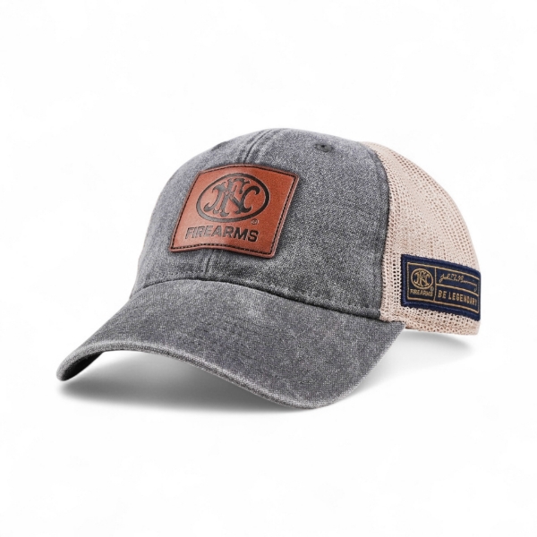 Angled front view of gray denim trucker cap with tan mesh back and brown leather FNH Firearms patch on front.